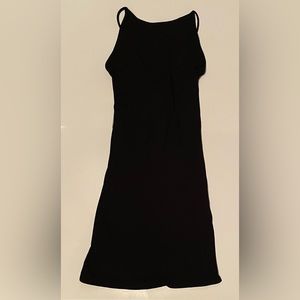 Black knee length dress. Open back.